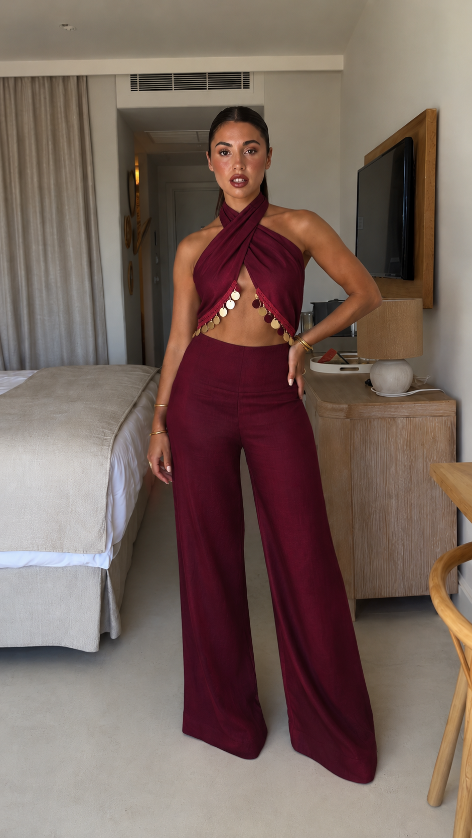 Front view of burgundy cross halter cutout wide-leg jumpsuit